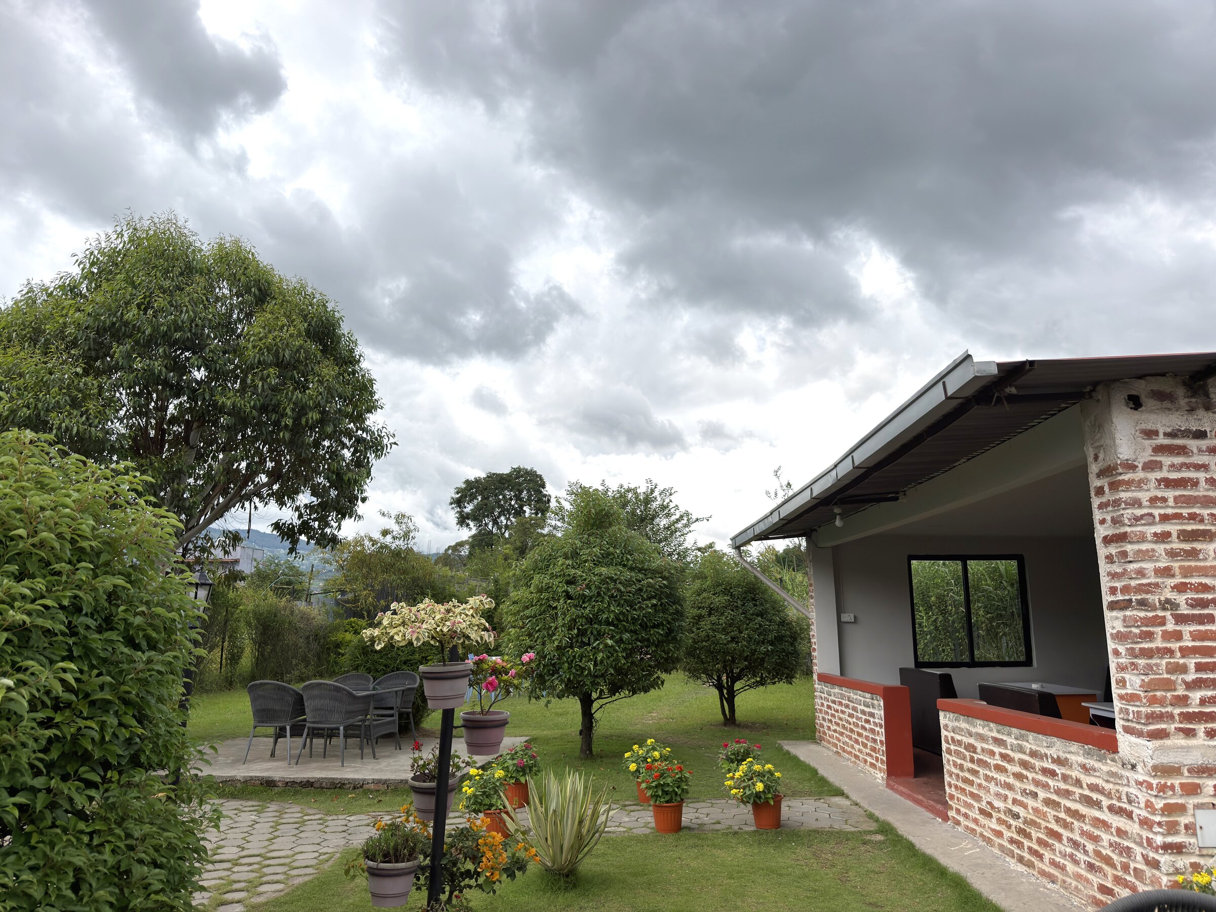 Outdoor lounge nook with seating beneath a sloped roof