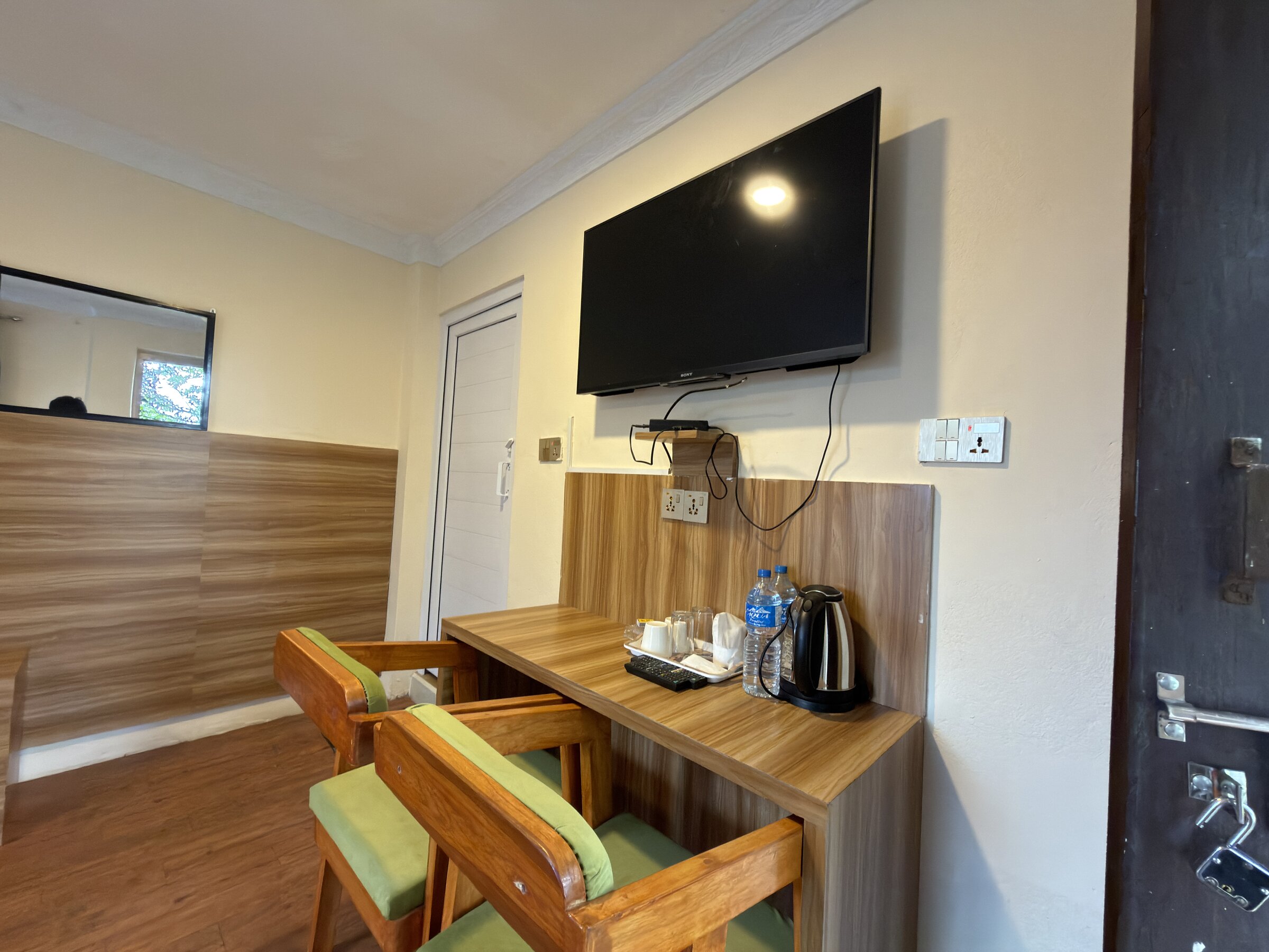 Room work desk and seating nook with television and tea and coffee amenities